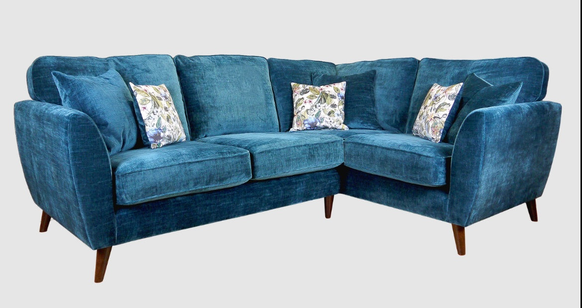 Teal Corner Sofa with floral cushions